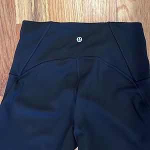 Lululemon black 25” leggings with sheer panel in back of legs.